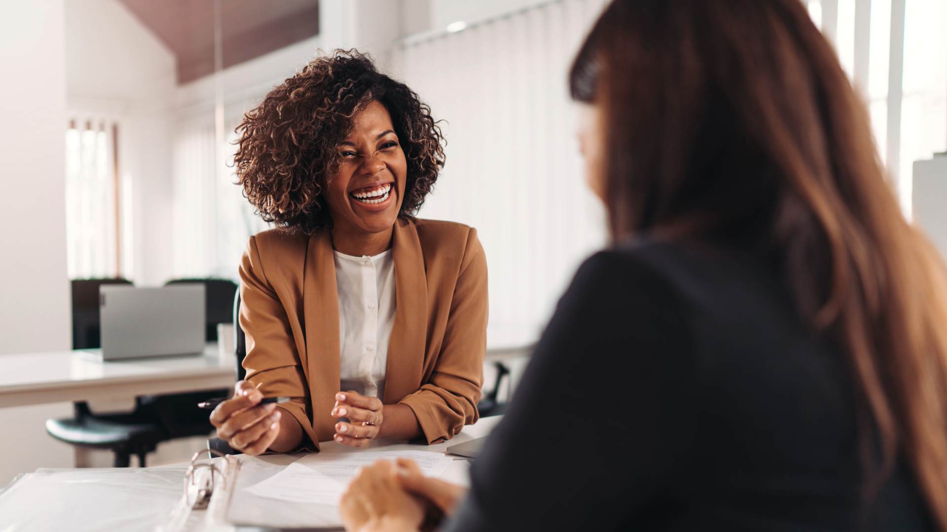 Women laughing at meeting_compressed Women laughing at meeting
