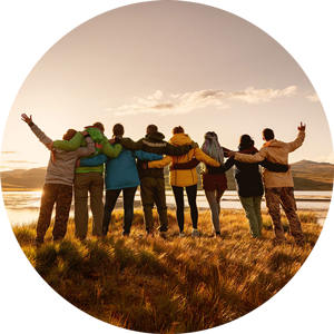 group of people hugging at sunset